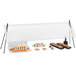 A Cal-Mil rectangular sneeze guard with a clear plastic cover over sushi trays on a table.