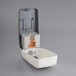 A Safeguard touchless hand sanitizer dispenser in white plastic with an open lid.