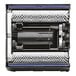 A black and silver Tornado walk behind cylindrical floor scrubber with blue accents.