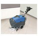 A Powr-Flite Predator cordless walk behind floor scrubber machine cleaning a tile floor.
