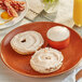 A plate of bagels with Smoked Salmon Cream Cheese Spread and bacon.