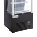 An Avantco black refrigerated air curtain merchandiser with a glass door.