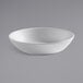 An American Metalcraft white matte melamine bowl on a gray surface.