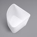 An American Metalcraft white plastic quarter round serving bowl with a curved corner.