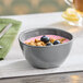 An American Metalcraft storm melamine bouillon cup filled with yogurt and blueberries on a table.