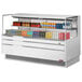 A white Turbo Air horizontal refrigerated open curtain merchandiser with drinks and snacks on shelves.