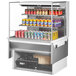 A Turbo Air white drop-in refrigerated open display case with cans of soda and beer on shelves.