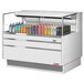 A Turbo Air white horizontal refrigerated curtain merchandiser filled with drinks on a counter.