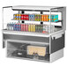 A Turbo Air drop-in refrigerated display case with cans of soda and different flavors on shelves.