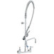 A silver T&S EasyInstall wall mounted pre-rinse faucet with hose and sprayer.