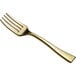 A close-up of a Visions gold plastic tasting fork.