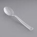 A clear plastic Visions tasting spoon on a gray surface.