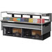 A Turbo Air drop-in refrigerated display case with drinks for sale.