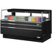 A black Turbo Air refrigerated curtain merchandiser with a variety of cans including soda.