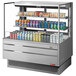 A Turbo Air stainless steel horizontal refrigerated display case with drinks and beverages.