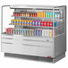 A Turbo Air stainless steel horizontal refrigerated open curtain merchandiser with soda cans inside.