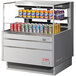 A Turbo Air horizontal refrigerated curtain merchandiser with cans of soda on a shelf.