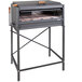 A grey rectangular Nuke BBQ Pampa charcoal grill on a table with a wooden tray.