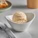 A bowl of Oringer cake batter ice cream with a spoon.