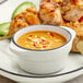 A plate of food with Acopa Embers grey stoneware sauce cups filled with sauce.