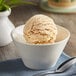 A bowl of Oringer cake batter ice cream with a spoon.