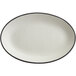 An Acopa grey matte coupe stoneware platter with an oval shape and black rim.