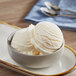 A bowl of lemon ice cream with a spoon.