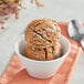 A bowl of brown ice cream with Oringer Buttercream Frosting variegate on top.