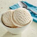 A bowl of Oringer Irish Creme hard serve ice cream with a spoon next to it.