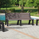 A group of brown MasonWays Malibu-style benches with black legs sitting in front of a pool.