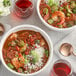 A bowl of red beans and rice with vegetables seasoned with McCormick Culinary Bayou Cajun Seasoning.