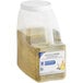 A plastic container of McCormick Culinary Lemon and Pepper seasoning with a white lid and a yellow spice mixture.