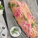 A fish fillet with McCormick Culinary Lemon and Pepper Seasoning Salt and pink onions on top.