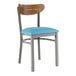 A Lancaster Table & Seating Boomerang chair with a blue vinyl seat and vintage wood back and metal legs.