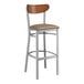 A Lancaster Table & Seating bar stool with a brown cushioned seat.