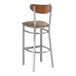 A Lancaster Table & Seating bar stool with a taupe cushion and wood back.