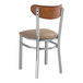 A Lancaster Table & Seating Boomerang Series wood and metal chair with a taupe cushion.