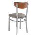 A Lancaster Table & Seating metal chair with a dark gray cushion on the seat and back.