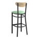 A Lancaster Table & Seating bar stool with a seafoam vinyl cushion and black frame.