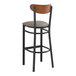 A Lancaster Table & Seating black bar stool with dark gray vinyl seat.