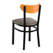 A black metal chair with a dark gray vinyl seat and a curved cherry wood backrest.
