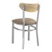 A Lancaster Table & Seating metal and wood chair with a taupe cushion.