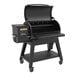 A black Louisiana Grills pellet grill with a black lid and table.