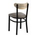 A black metal chair with a dark gray vinyl seat and a curved driftwood-finish backrest.
