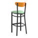 A Lancaster Table & Seating bar stool with a seafoam vinyl seat and black frame.