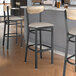 Lancaster Table & Seating Boomerang Series bar stools with driftwood backs and light gray seats.