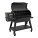 A Louisiana Grills Black Label 1200 pellet grill with a black lid open on a table.