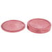 A red polyethylene round tortilla server with a circular surface and a circle in the middle.