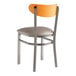 A Lancaster Table & Seating metal and wood chair with a dark gray vinyl seat and cherry wood back.