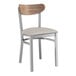 A Lancaster Table & Seating Boomerang chair with a light gray vinyl seat and vintage wood back.